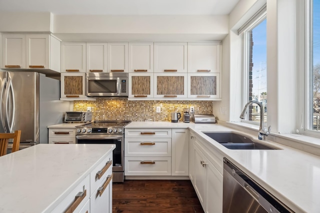 kitchen featuring tasteful backsplash, stainless steel appliances, sink, white cabinets, and dark hardwood / wood-style floors