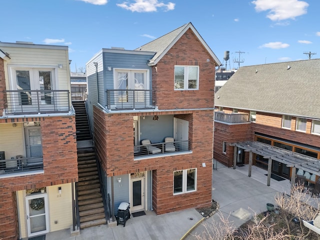 rear view of property featuring a balcony