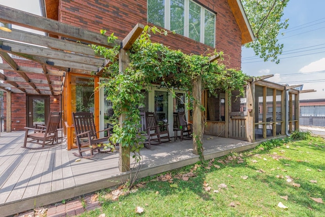 wooden terrace with a pergola and a sunroom