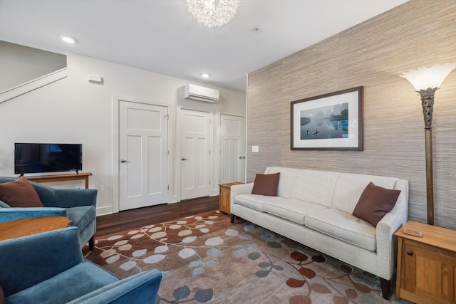 living room with an AC wall unit, dark wood-type flooring, and a chandelier