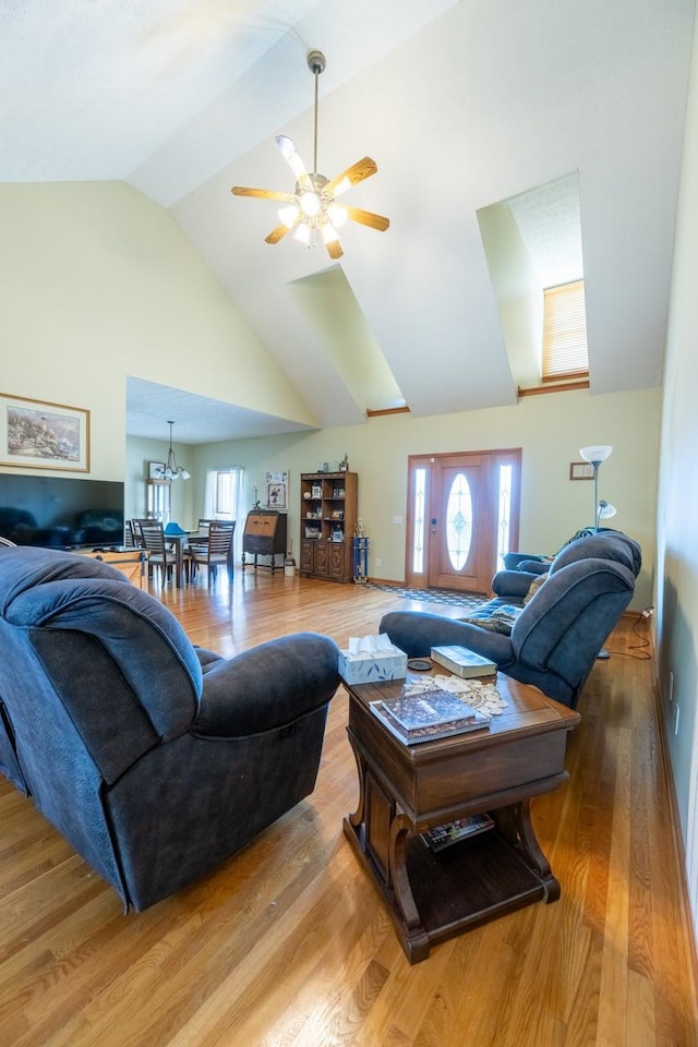 living room featuring ceiling fan, vaulted ceiling, a wealth of natural light, and hardwood / wood-style floors