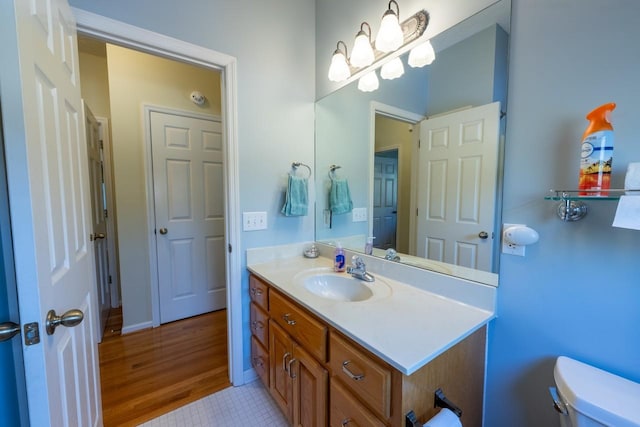 bathroom featuring toilet, vanity, and tile patterned floors