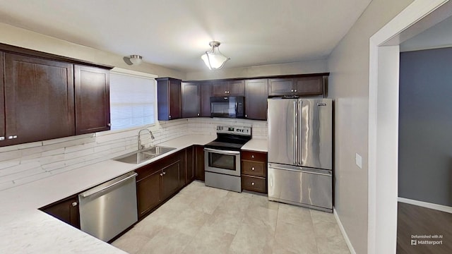 kitchen with backsplash, sink, stainless steel appliances, and dark brown cabinets