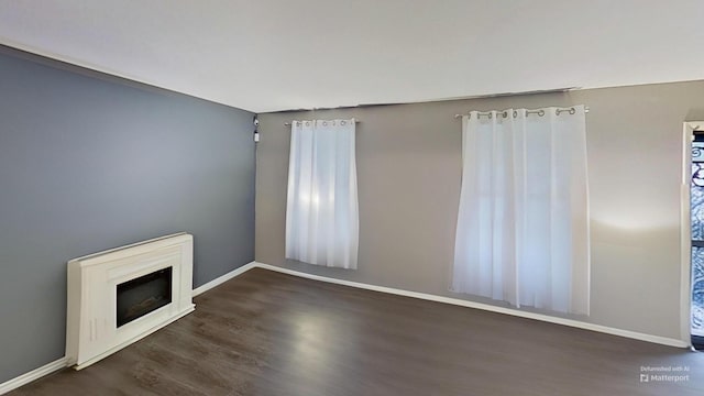 unfurnished living room featuring dark hardwood / wood-style floors