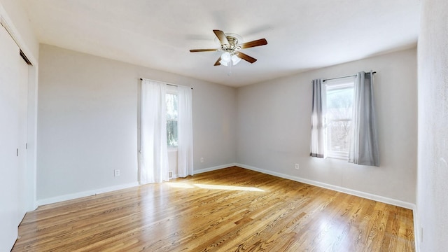 spare room with light wood-type flooring and ceiling fan