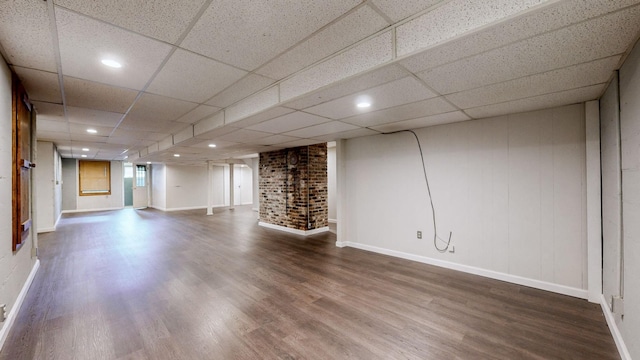 basement with a drop ceiling and wood-type flooring