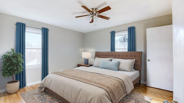 bedroom with light wood-type flooring and ceiling fan