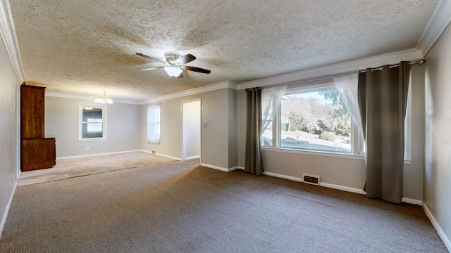 carpeted empty room with ceiling fan, a textured ceiling, a wealth of natural light, and ornamental molding