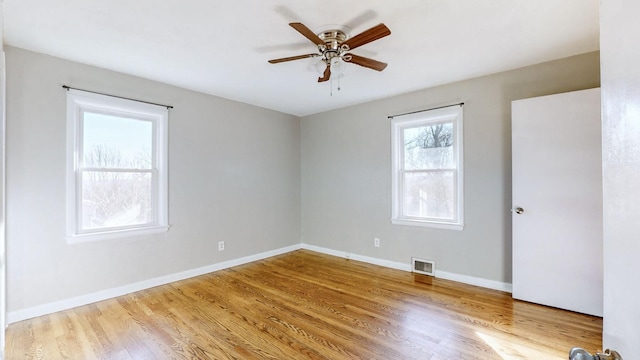 spare room featuring ceiling fan and light hardwood / wood-style flooring