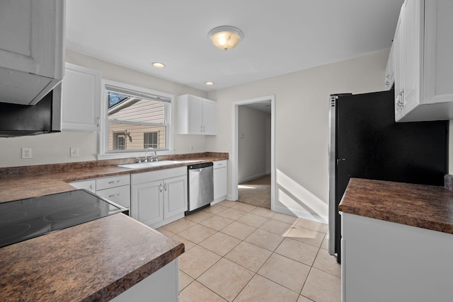 kitchen with light tile patterned flooring, sink, white cabinets, and stainless steel appliances