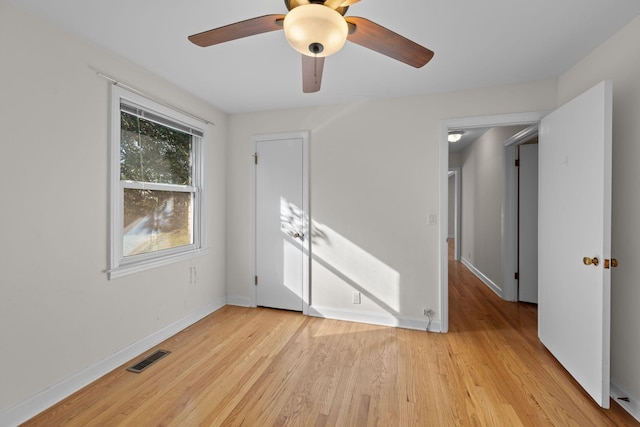 empty room with light hardwood / wood-style floors and ceiling fan