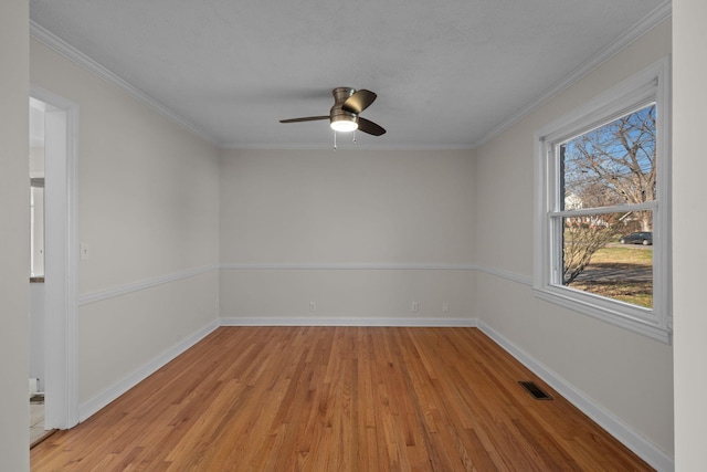 unfurnished room featuring ceiling fan, light hardwood / wood-style flooring, and ornamental molding