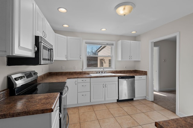 kitchen with light colored carpet, white cabinetry, sink, and appliances with stainless steel finishes