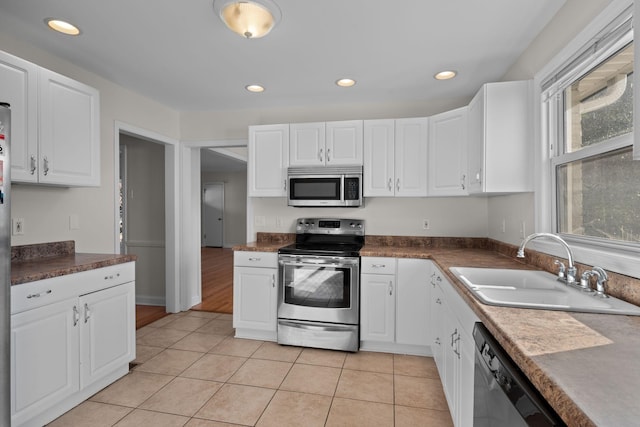 kitchen featuring a healthy amount of sunlight, white cabinetry, sink, and appliances with stainless steel finishes