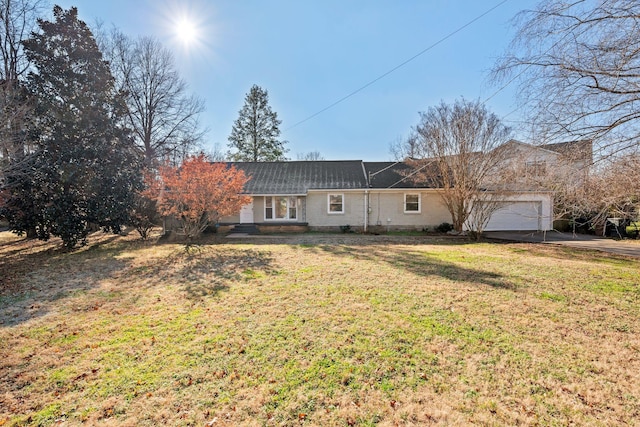 single story home featuring a garage and a front yard