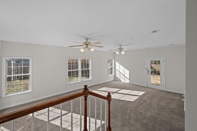 spare room featuring carpet flooring and ceiling fan