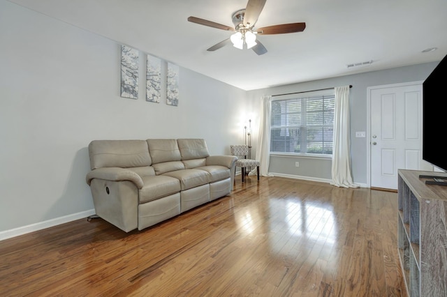 living room featuring ceiling fan and hardwood / wood-style floors