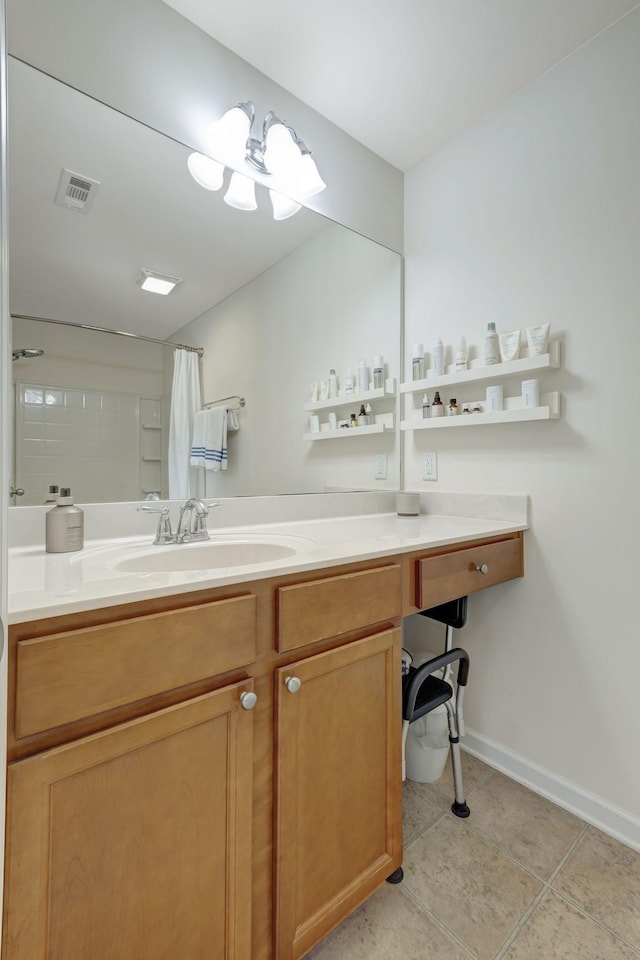 bathroom featuring tile patterned flooring, a shower with curtain, and vanity