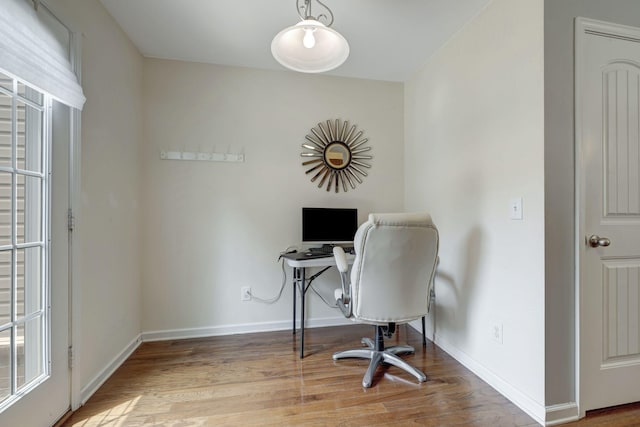 home office with light hardwood / wood-style floors