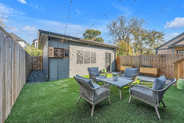 rear view of property featuring an outdoor structure and a lawn