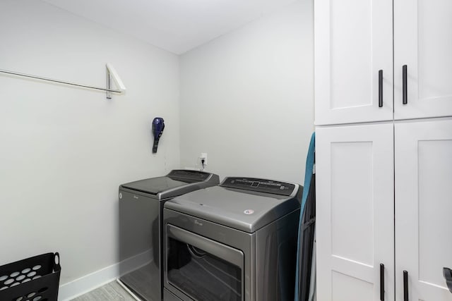 laundry room featuring cabinets and washing machine and dryer