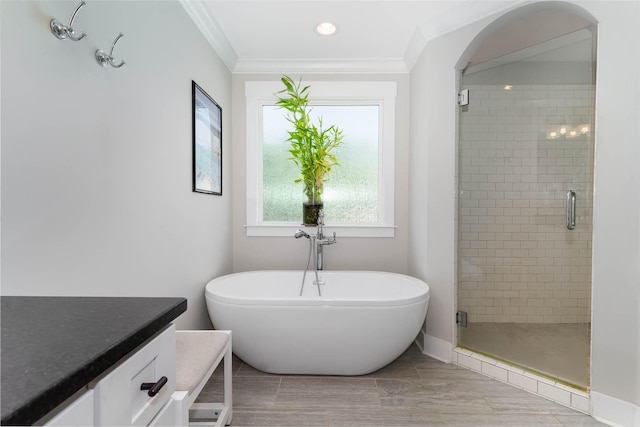 bathroom featuring vanity, separate shower and tub, and crown molding