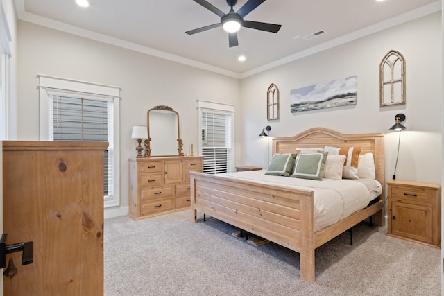 bedroom featuring ceiling fan, crown molding, and light colored carpet