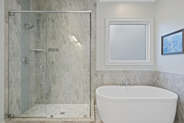 bathroom featuring tile walls and plus walk in shower