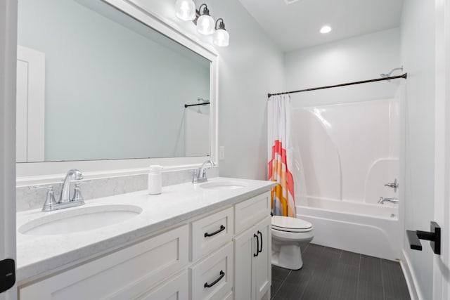 full bathroom featuring tile patterned floors, toilet, vanity, and shower / bath combination with curtain