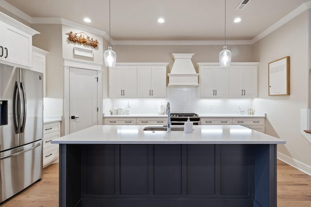 kitchen featuring hanging light fixtures, white cabinets, stainless steel appliances, and custom exhaust hood