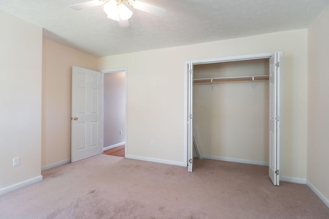 unfurnished bedroom featuring carpet, a closet, baseboards, and ceiling fan