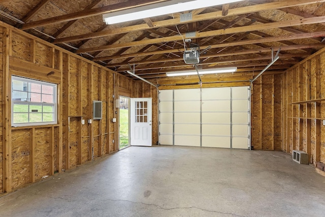 garage with electric panel and a garage door opener