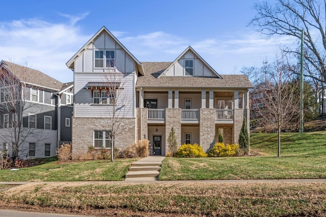 view of front of property featuring a balcony and a front yard