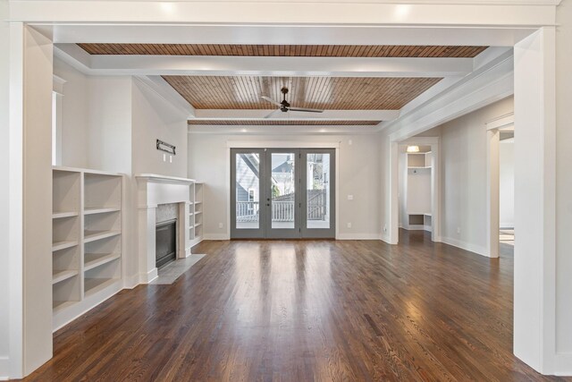 unfurnished living room featuring beamed ceiling, ceiling fan, dark hardwood / wood-style floors, and built in shelves