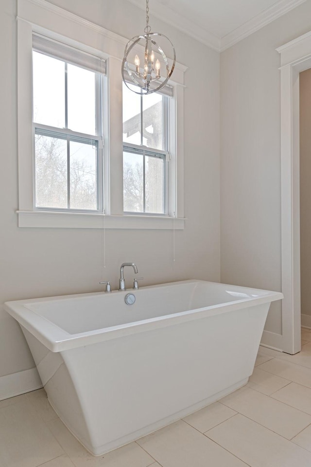 bathroom with ornamental molding, tile patterned flooring, a bath, and a notable chandelier