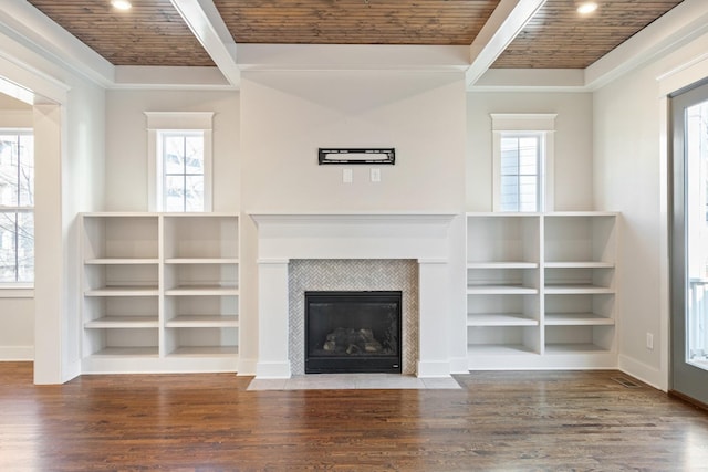 unfurnished living room featuring plenty of natural light, wood ceiling, and a tile fireplace