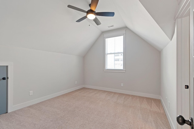 bonus room featuring ceiling fan, light carpet, and vaulted ceiling