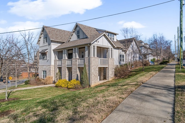 view of home's exterior featuring a balcony and a lawn