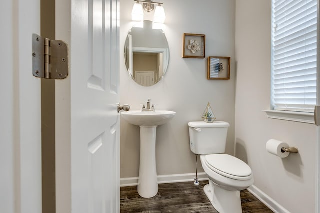 bathroom with sink, hardwood / wood-style floors, and toilet