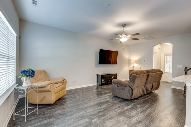 living room featuring ceiling fan and dark hardwood / wood-style floors