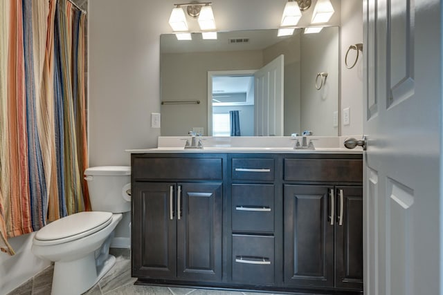 bathroom with vanity, toilet, and walk in shower