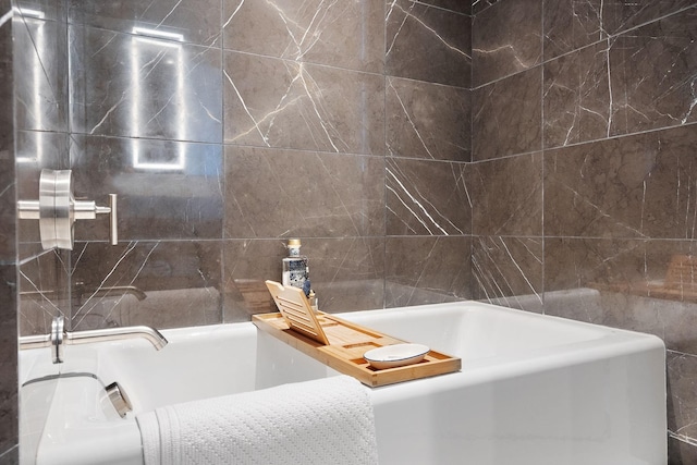 bathroom with a bath and tile walls