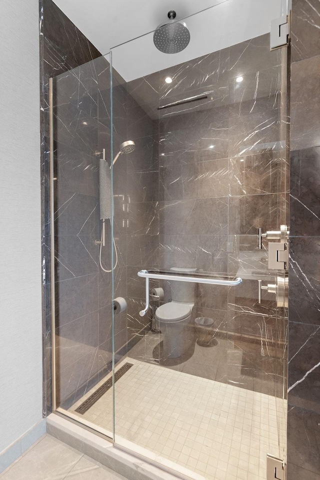 bathroom with tile patterned flooring, toilet, and walk in shower