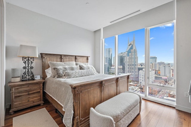 bedroom with dark wood-type flooring