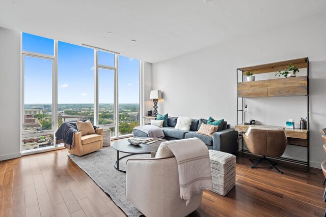 living room with floor to ceiling windows and dark wood-type flooring