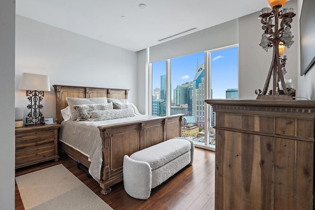 bedroom with dark wood-type flooring