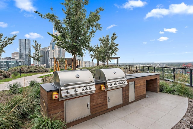 view of patio with area for grilling and a grill