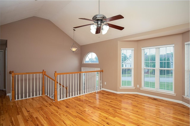 unfurnished room with ceiling fan, light hardwood / wood-style floors, and lofted ceiling