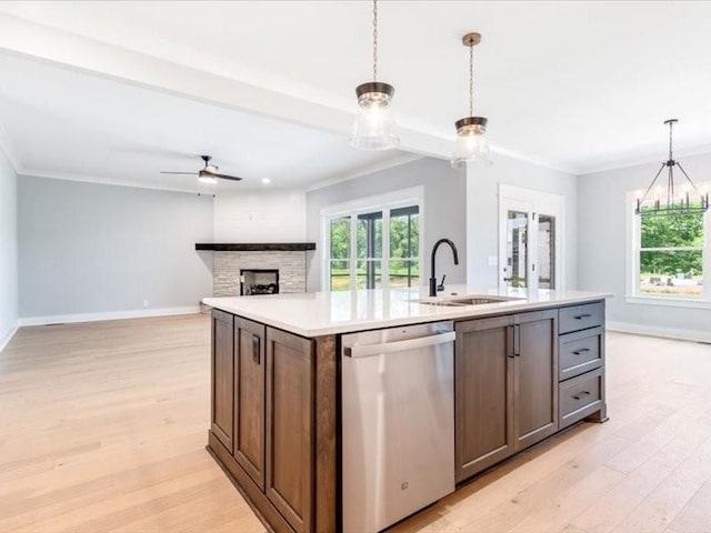 kitchen with sink, decorative light fixtures, a center island with sink, light hardwood / wood-style flooring, and dishwasher