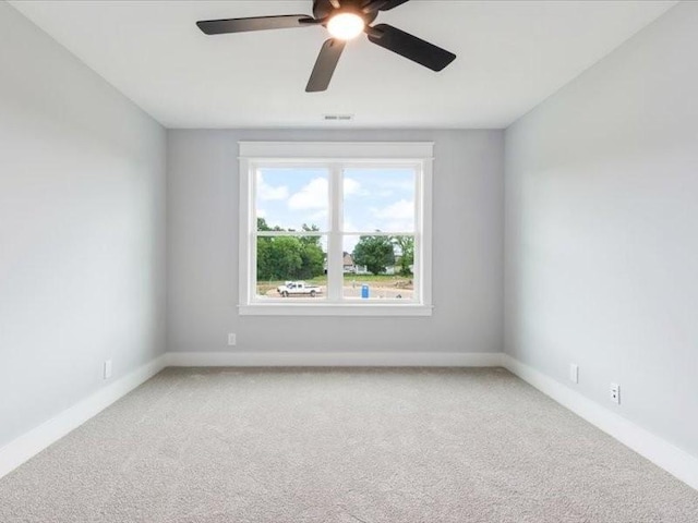 empty room with ceiling fan and carpet floors